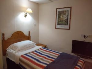 A bed or beds in a room at Chadwick House Hotel