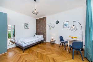 1 dormitorio con 1 cama, mesa y sillas en Slavikova 18 en Praga