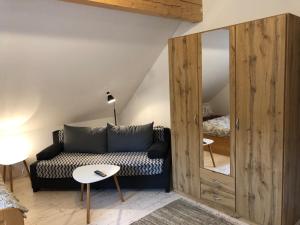 a living room with a couch and a mirror at Apartmán U Setra in Pec pod Sněžkou