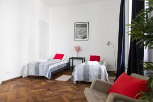 a living room with two beds and a couch at Apartamenty Królewska in Lublin