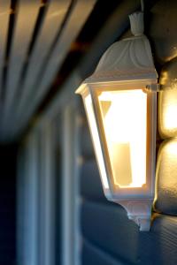 a light on the side of a house at Nátthagi Luxury Cottage in Snæfellsbær