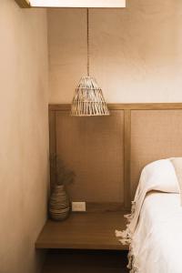 a pendant light hanging over a bed in a bedroom at Casa Montore by Barrio Mexico in Guadalajara