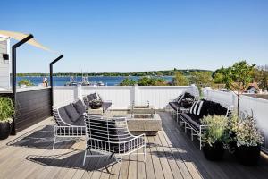 a patio with chairs and a table on a deck at The Menhaden Hotel in Greenport