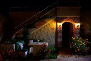 a brick building with a table in a yard at night at Mandarin & Mango Boutique Hotel in Faralya