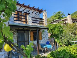 a stone house with a view of the garden at Analipsi Sea View Villa in Pouríon