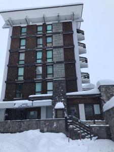 a building with snow on the ground in front of it at Una Finestra sul Cervino in Breuil-Cervinia +47 photos