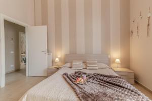 a bedroom with a bed with a blanket and two lamps at La Casa Rosa in Terni