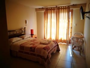 Postel nebo postele na pokoji v ubytování Las Cumbres INN