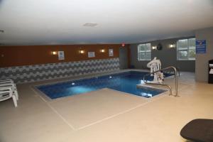 a large swimming pool in a large room with at La Quinta by Wyndham Montgomery in Montgomery