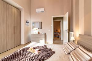 a bedroom with a bed with a blanket at La Casa Rosa in Terni