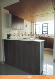 a kitchen with a large island in a room at Sueños Vividos Hospedaje in Sogamoso