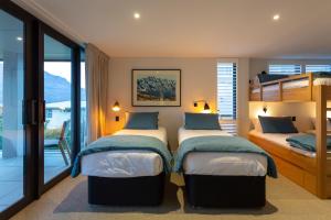 a bedroom with two bunk beds and a balcony at Whakarire in Queenstown