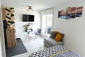 una pequeña sala de estar con cama y sofá en Sunny Studio Disneyland Paris en Montévrain