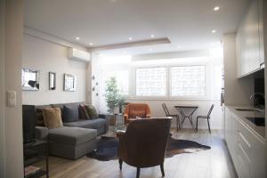 a living room with a couch and a table at FLH Campo de Ourique Bright Apartment in Lisbon