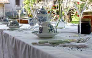 a table with blue and white vases and silverware on it at Silenzio e Buio in Calizzano