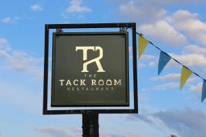 a sign for the tack room restaurant on a pole at The Wensleydale Hotel in Middleham