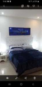 a bedroom with a large bed with a blue blanket at Apartamento Morros Epic Cartagena in Cartagena de Indias