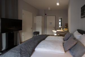 a bedroom with a bed with a flat screen tv at Premium Apartment München Messe in Munich