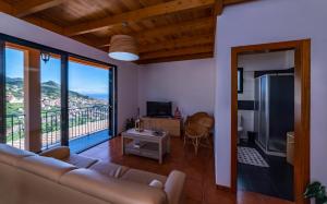 a living room with a couch and a balcony at Casa Miguel in Machico