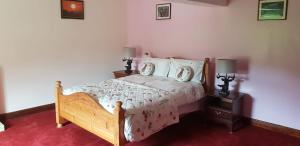 a bedroom with a bed and two night stands at Lower Turnerford Farmhouse in Newby