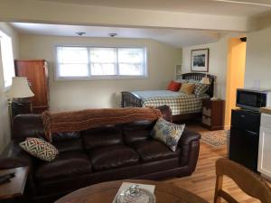 a living room with a couch and a bed at 14 Charles St Apartment in Guilford