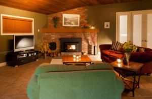 a living room with a couch and a fireplace at Kelowna family Retreat in the middle of Everywhere in Kelowna