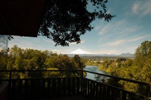 a view of a mountain from a balcony with a river at Cabañas Portal del Rio in Villarrica