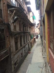 an alley in an old city with buildings at Ajima Guest House in Bhaktapur