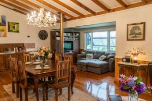 a dining room and living room with a table and chairs at Wyndover Mountain Retreat in Beechmont