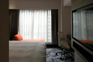 Rúm í herbergi á Tango Inn Taipei ZhongShan