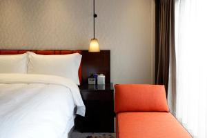 Rúm í herbergi á Tango Inn Taipei ZhongShan