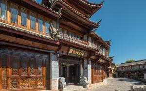 a building in an asian city with wooden architecture at Orchid Land Boutique Inn in Lijiang