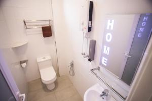 a bathroom with a toilet and a sink and a mirror at casa 96 villa in Kuantan