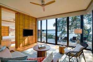 a living room with a large glass wall at Six Senses Krabey Island in Koh Krabey