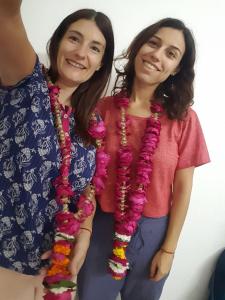 two women standing next to each other wearing beads at Aradhana's Home Stay in Agra