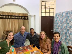 a group of people sitting around a table at Aradhana's Home Stay in Agra