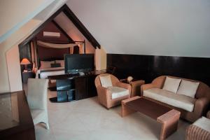 a living room filled with furniture and a tv at Boracay Mandarin Island Hotel in Boracay