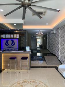 a hotel lobby with two stools at a bar at Elmark Hotel Kuantan in Kuantan