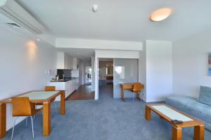 a living room with a couch and a table at Sea Side 110 in Mandurah