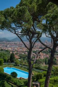 a beach with trees and palm trees at Hotel Torre di Bellosguardo in Florence