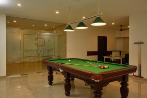 a pool table sitting inside of a room with ahibition at The Continentti Whitefield in Bangalore