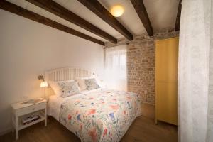 a small bedroom with a bed and a window at Mulberry Stonehouse in Primošten