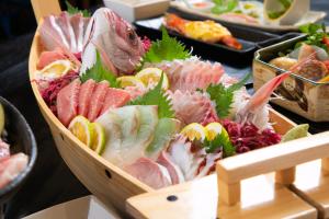 a tray of food with different types of sushi at Yasuraginoyado Yufu in Beppu