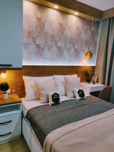 a bedroom with a bed with two pillows on it at Apartment A5 Lux in Jahorina