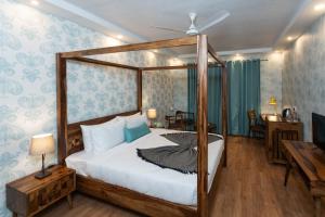 a bedroom with a canopy bed and a table at The G Snoozebox in Udaipur +74 photos