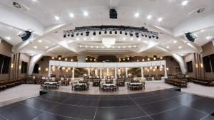 an empty concert hall with a stage and tables and chairs at Wine & Spa Complex Starosel in Starosel +75 photos