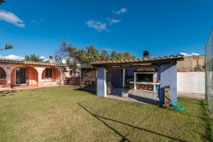 a backyard of a house with a fireplace at Villa Serra in Quartu SantʼElena