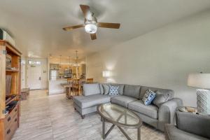 a living room with a couch and a ceiling fan at Wailea Grand Champions in Wailea