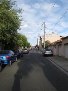 a shadow of a person walking down a street at Les Algues du Grau in Le Grau-dʼAgde