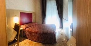 Postel nebo postele na pokoji v ubytování Hotel San Carlo